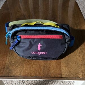 Cotopaxi Black Fanny Pack with Red and Blue Accents